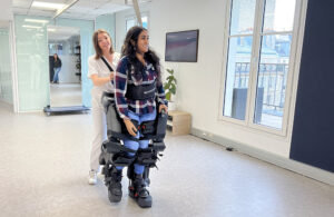 A person walking with a Wandercraft exoskeleton.
